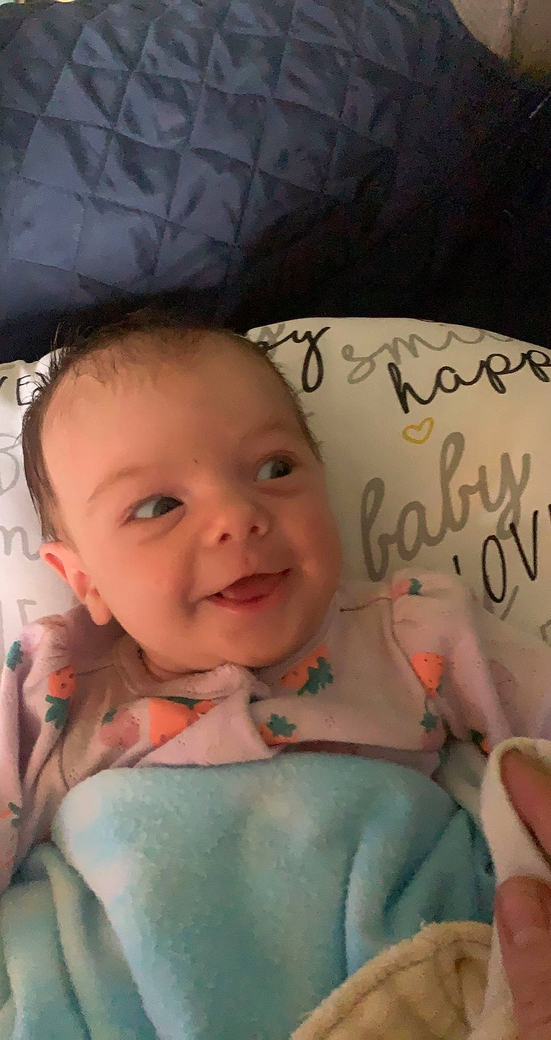 Irie is registered to the contest to win money with this photo: baby, baby_toddler_clothing, cheek, child, comfort, eyebrow, face, finger, fun, happy, head, iris, joy, linens, lip, mouth, person, pink, skin, smile