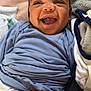 Jakai Kyrie is registered to the contest to win money with this photo: baby, smiling, infant, blue_clothing, blanket, lying_down, happy, face, skin, arm, closeup, child, cute, indoors, soft_texture, comfort, joy, person, portrait, young