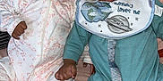 Jakai Kyrie joined the competition — help win amazing prizes! baby, infant, smiling, happy, lying_down, onesie, bib, pacifier, bed, soft_surface, cute, two_babies, holding_hands, skin, foot, face, expression, child, indoors, cozy