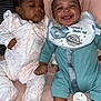 baby, infant, smiling, happy, lying_down, onesie, bib, pacifier, bed, soft_surface, cute, two_babies, holding_hands, skin, foot, face, expression, child, indoors, cozy