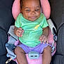 Jakiya Lyn joined the competition — help win amazing prizes! baby, child, car_seat, green_shirt, purple_shorts, smiling, infant, cute, seatbelt, pink_pillow, hands, feet, indoors, happy, young_child, portrait, safety, clothing, person, seat