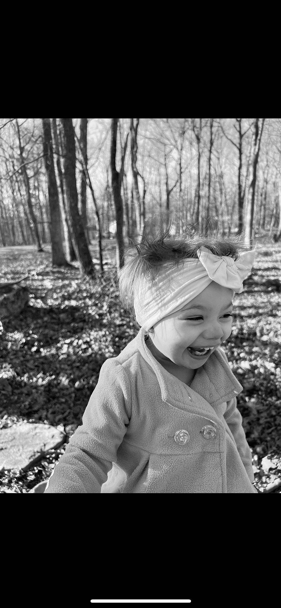 Ariella is registered to the contest to win money with this photo: black_and_white, cap, child, flash_photography, forest, fun, grass, happy, headwear, joy, laugh, monochrome, monochrome_photography, people_in_nature, person, plant, smile, stock_photography, style, toddler