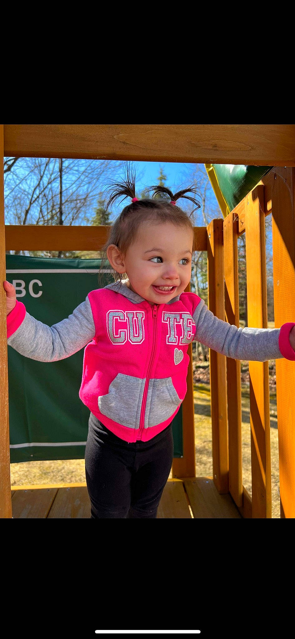 Ariella is registered to the contest to win money with this photo: baby, baby_toddler_clothing, child, electric_blue, face, fun, happy, joy, leggings, leisure, magenta, outdoor_play_equipment, person, pink, recreation, sky, sleeve, smile, t_shirt, toddler