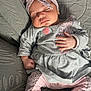 Angélina participe au concours pour gagner de l'argent avec cette photo : baby, sleeping, headband, grey_clothing, pink_clothing, boots, cozy, infant, cute, peaceful, resting, hand, face, closed_eyes, soft_texture, fabric, indoors, portrait, child, comfort