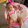 toddler, child, pink_bow, hello_kitty, chair, carpet, indoor, clothing, onesie, baby, foot, hand, face, hair_bow, furniture, person, cute, relaxed, toy, playful
