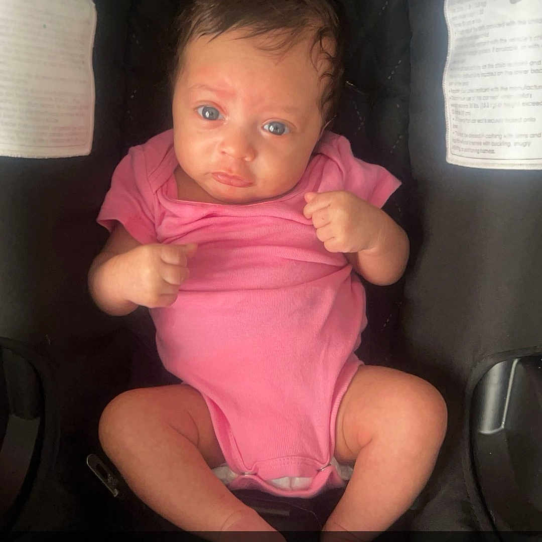 Mylah is registered to the contest to win money with this photo: baby, bodypart, car, clothing, cushion, face, finger, furniture, hand, head, homedecor, newborn, person, photography, portrait, shorts, sitting, t_shirt, transportation, vehicle