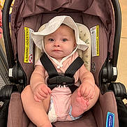 Aaliyah joined the competition — help win amazing prizes! baby, infant, car_seat, hat, white_hat, straps, sitting, indoor, child, cute, pink_clothing, foot, hand, face, expression, seat, safety, person, young_child, adorable