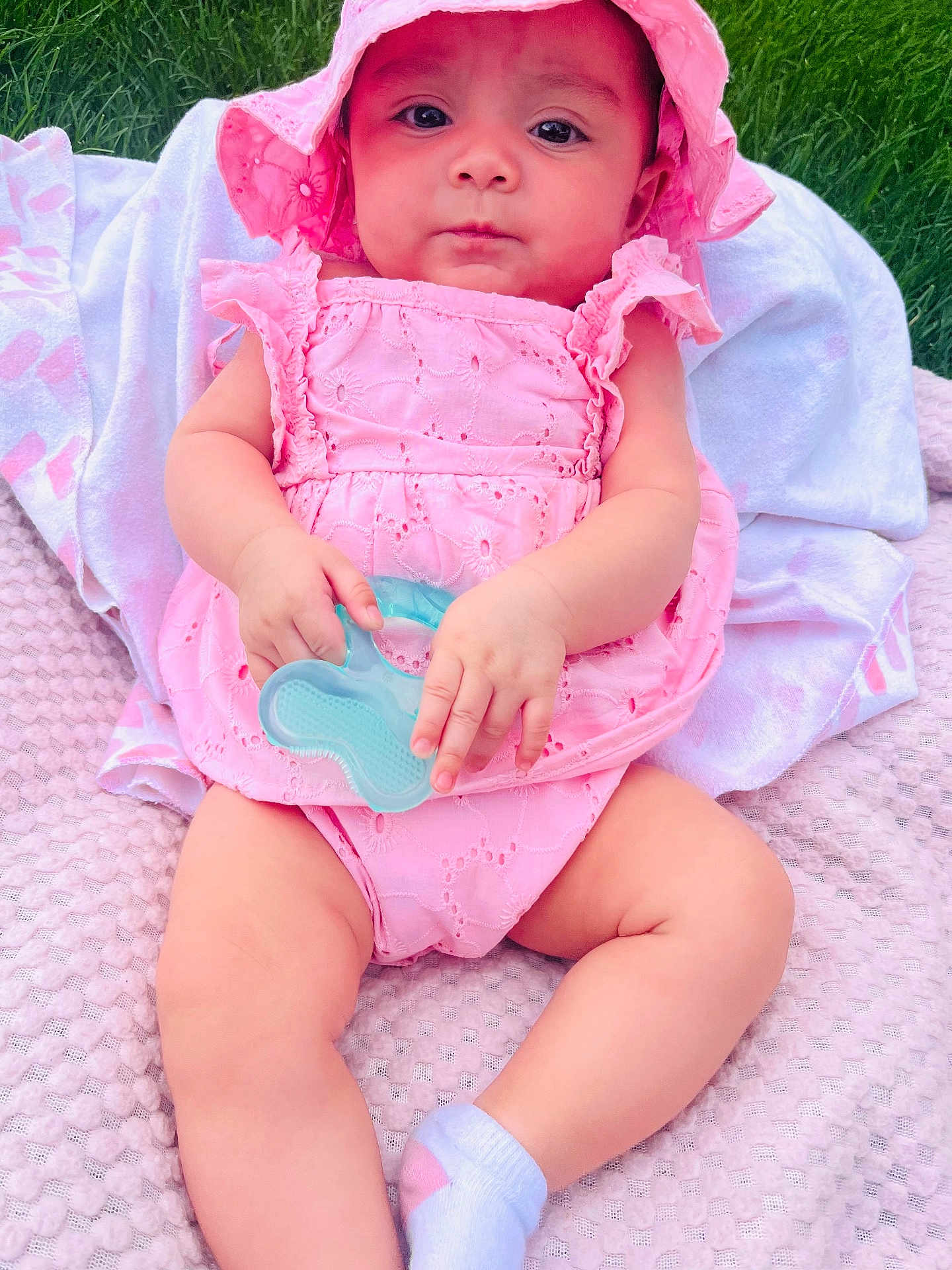 Jireth joined the competition — help win amazing prizes! baby, infant, pink_dress, sunhat, teething_toy, blanket, grass, outdoor, child, cute, sitting, sock, summer, portrait, closeup, person, soft_texture, young_child, baby_girl, playtime