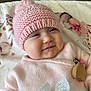 Giulia participe au concours pour gagner de l'argent avec cette photo : baby, infant, child, pink_hat, knit_hat, blanket, smiling, portrait, closeup, cheeks, clothing, pacifier_clip, wooden_teether, bow, cozy, home, lying_down, adorable, eyes_squint, soft_texture