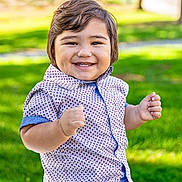 Dominic joined the competition — help win amazing prizes! toddler, child, smiling, outdoor, bench, grass, park, happy, shirt, pants, face, person, nature, greenery, daylight, cute, portrait, sitting, casual_clothing, sunny