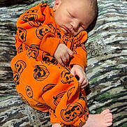 Grayson joined the competition — help win amazing prizes! newborn, baby, sleeping, orange_clothing, pumpkin_pattern, onesie, infant, blanket, camo_pattern, feet, hands, cute, cozy, resting, child, portrait, indoors, soft_texture, peaceful, young