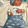 newborn, baby, infant, clothing, hat, blanket, hospital, wristband, bandage, dragonfly, pattern, sleeping, lying_down, cute, child, person, soft, comfort, small, portrait