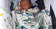 Waylan joined the competition — help win amazing prizes! newborn, baby, blanket, dinosaur_pattern, sleeping, infant, baby_carrier, cozy, soft_fabric, child, cute, resting, indoors, head, face, clothing, comfort, toddler, peaceful, portrait