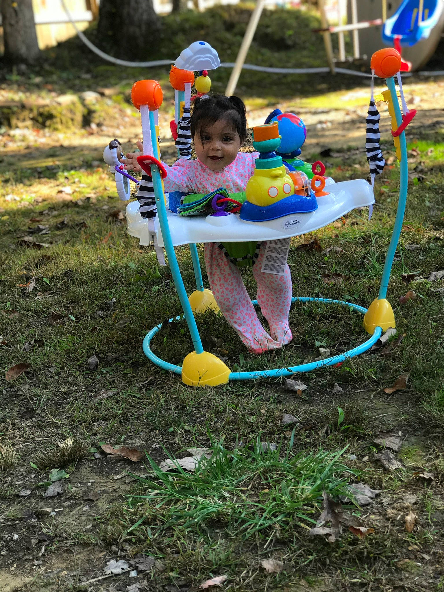 Jocelynn is registered to the contest to win money with this photo: baby, child, city, fun, grass, happy, leisure, outdoor_play_equipment, party_supply, person, plant, play, playground, recreation, sitting, smile, soil, sports_toy, swing, toddler