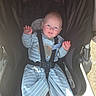 baby, baby_clothes, baby_seat, babywear, blue_eyes, child, clothing, cute, happy, infant, infant_care, outdoor, pajamas, person, portrait, seatbelt, smiling, stroller, sunlight, waving