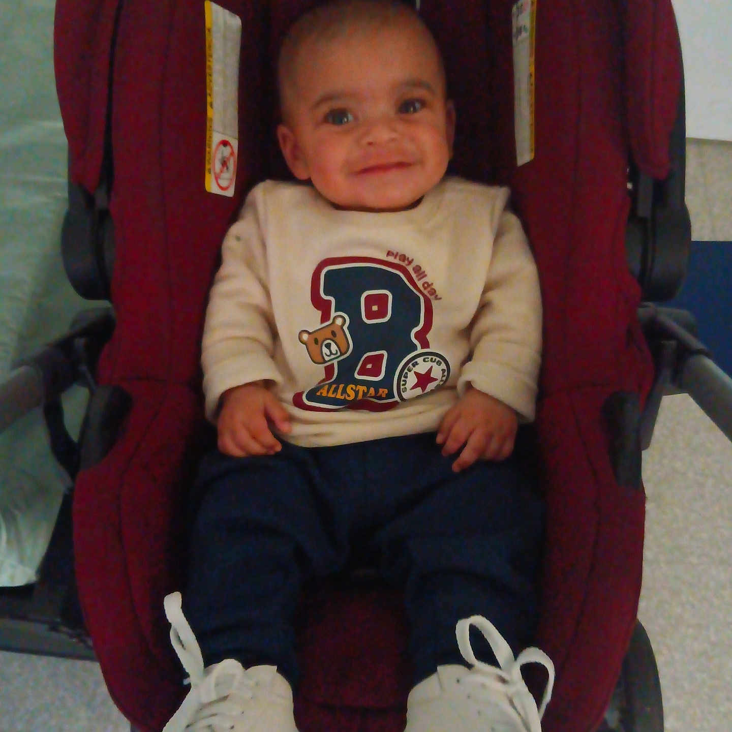 Noah Joseph joined the competition — help win amazing prizes! baby, baby_boy, casual, child, clothing, cute, face, footwear, happy, indoor, infant, pants, person, playful, seated, shoes, smile, stroller, sweater, white_shoes