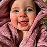 baby, smile, blue_eyes, pink_towel, fluffy, close_up, happy, child, face, skin, infant, cute, portrait, young, warm, soft_texture, indoors, expression, hooded, person