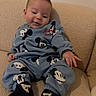 baby, beige_couch, child, couch, cozy, cute, fabric, hand, home_interior, infant, mickey_mouse, pajamas, portrait, relaxed, sitting, small_person, smile, socks, sweatshirt, toddler