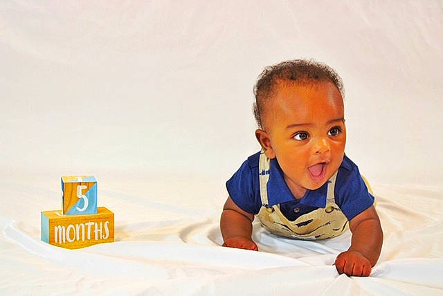 Alijah is registered to the contest to win money with this photo: baby, child, person, photography, play, room, sitting, smile, surprise, toddler, tummy_time, vacation