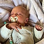 Néo participe au concours pour gagner de l'argent avec cette photo : baby, newborn, sleeping, pacifier, blanket, onesie, infant, sleeping_baby, pacifier_clip, beads, hand, cozy, bedding, soft_texture, embroidery, bunny_design, couch, portrait, peaceful, swaddle