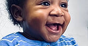 Jiquavious joined the competition — help win amazing prizes! baby, background, blue_shirt, child, closeup, curly_hair, cute, expression, face, hand, happy, holding, indoor, infant, joy, person, portrait, skin, smiling, striped_clothing