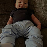 Zavier joined the competition — help win amazing prizes! baby, child, smiling, couch, clothing, pants, shirt, sitting, indoors, person, face, happy, infant, footwear, sock, young, cute, relaxed, portrait, home