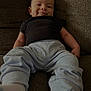baby, child, smiling, couch, clothing, pants, shirt, sitting, indoors, person, face, happy, infant, footwear, sock, young, cute, relaxed, portrait, home
