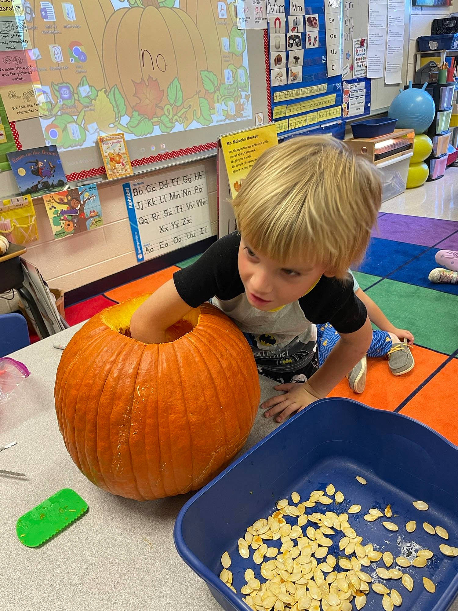 Christopher is registered to the contest to win money with this photo: art, calabaza, child, cucurbita, food, gourd, local_food, natural_foods, person, plant, produce, pumpkin, room, sharing, squash, toddler, vegetable, whole_food, winter_squash, wood