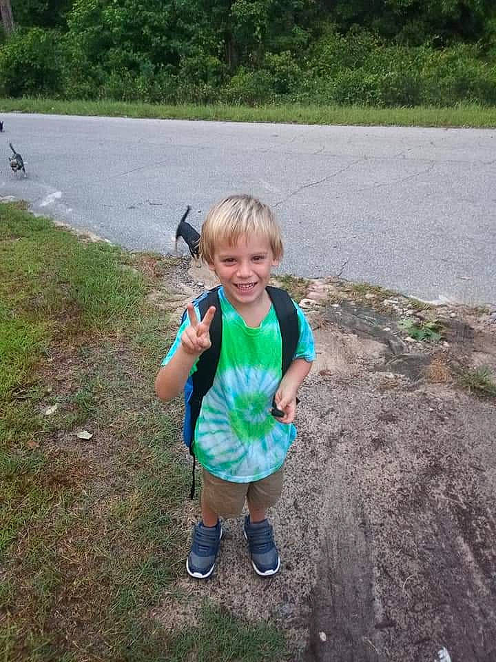 Christopher is registered to the contest to win money with this photo: asphalt, fun, garden, grass, grass_family, happy, joy, landscape, lawn, leisure, people_in_nature, person, plant, recreation, road, road_surface, shorts, smile, soil, t_shirt