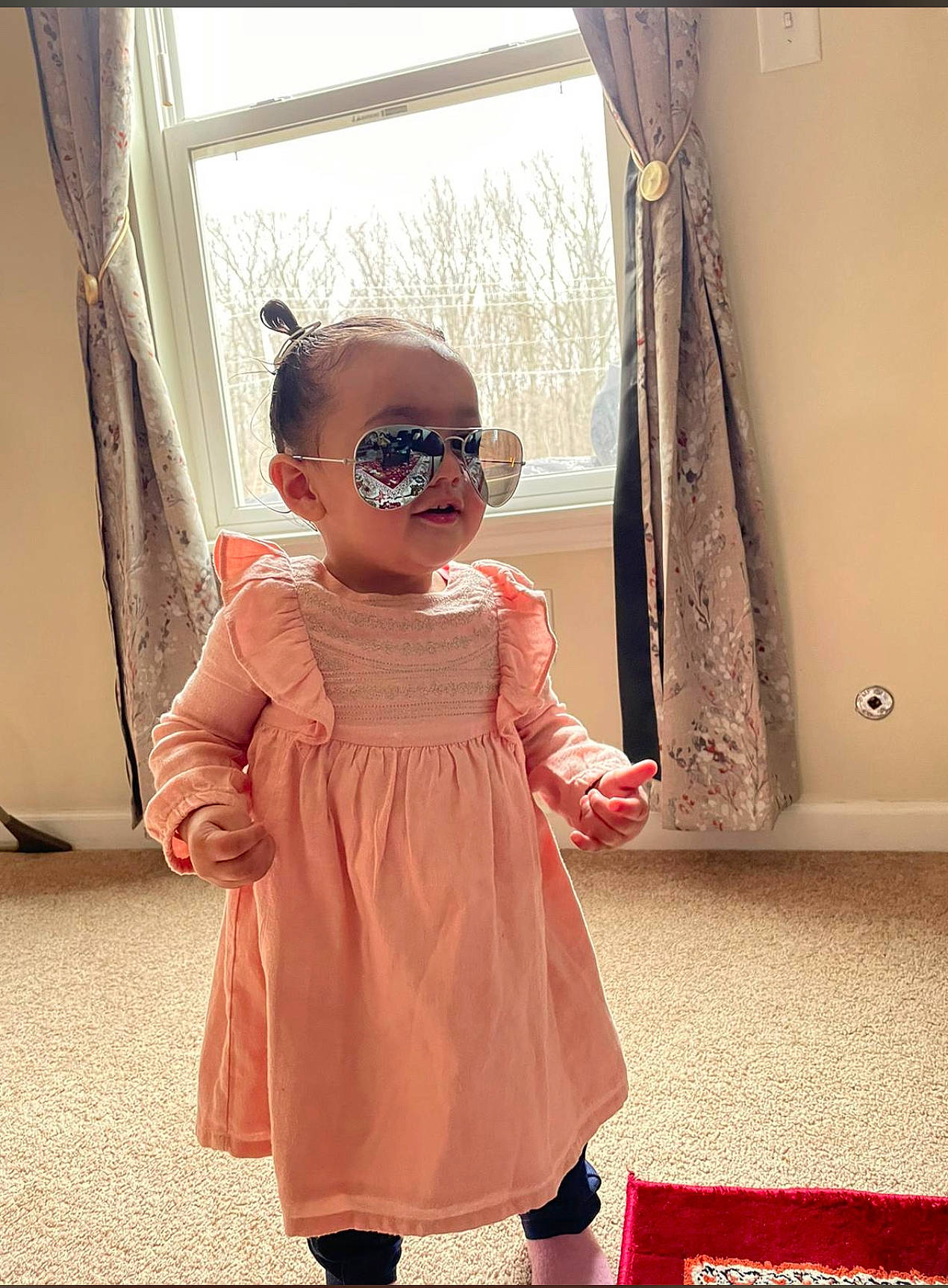 Seerat is registered to the contest to win money with this photo: baby_toddler_clothing, curtain, day_dress, dress, eyewear, fashion_design, flooring, glasses, goggles, hairstyle, happy, one_piece_garment, person, pink, shoulder, sleeve, sunglasses, textile, toddler, vision_care