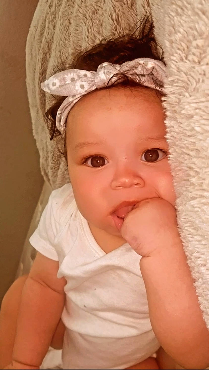 Amiyah Kehlani is registered to the contest to win money with this photo: baby, baby_toddler_clothing, cap, cheek, chin, comfort, eye, eyebrow, eyelash, face, facial_expression, happy, headgear, human_body, iris, lip, neck, nose, person, skin