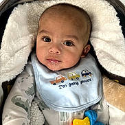 Aziel is registered to the contest to win money with this photo: baby, bib, blanket, child, clothing, comfort, cute, drool, expression, face, indoor, infant, person, play, portrait, sleepwear, soft, toy, warm, young