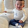 baby, child, toddler, smiling, happy, sitting, portrait, indoor, armchair, couch, furniture, living_room, home, clothing, long_sleeves, pants, socks, moon, stars, family_photo