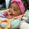 Ymiri Noelle is registered to the contest to win money with this photo: adorable, baby, baby_seat, child, closeup, clothing, colorful, curly_hair, cute, face, hand, happy, indoor, infant, pink_headband, playtime, portrait, smiling, soft_focus, teething_toy
