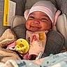 Ymiri Noelle is registered to the contest to win money with this photo: baby, blanket, car_seat, child, closeup, clothing, comfort, cozy, cute, face, happy, hat, indoor, infant, pacifier, pink, sitting, smiling, soft, warm