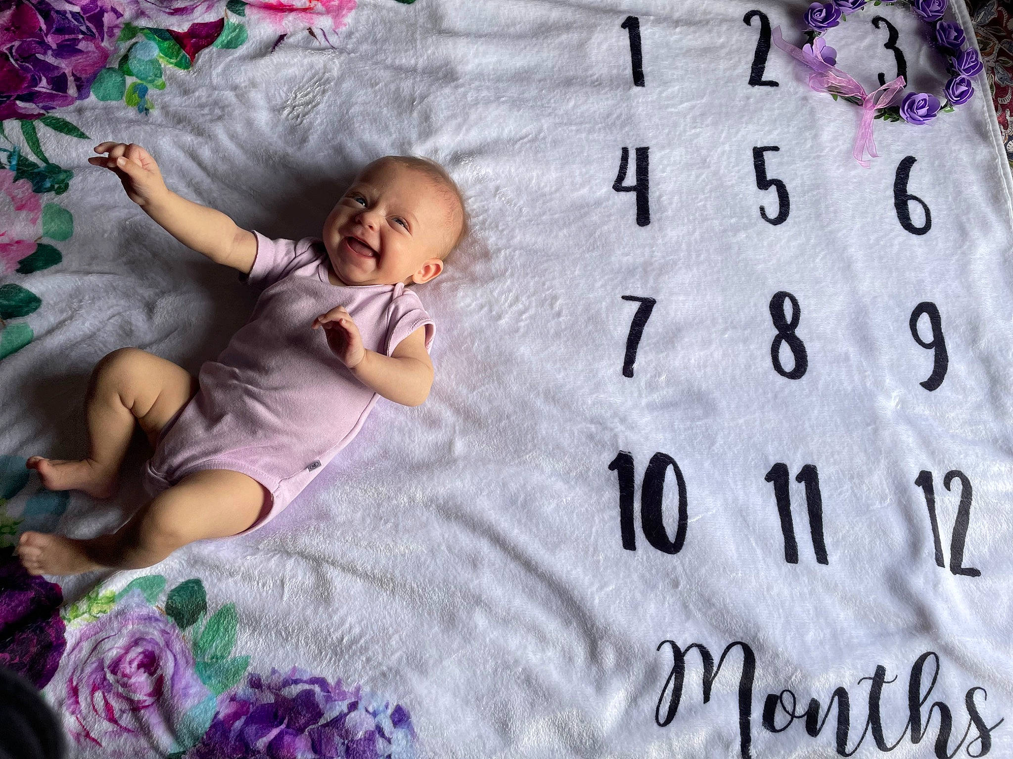 Lainey is registered to the contest to win money with this photo: baby, baby_toddler_clothing, bed, bedding, child, comfort, design, font, grass, happy, human, linens, magenta, pattern, person, pink, purple, room, t_shirt, textile
