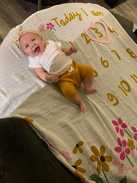 Evangeline joined the competition — help win amazing prizes! baby, baby_toddler_clothing, bed, bed_sheet, bedding, bedroom, bedtime, child, comfort, flooring, font, linens, pattern, person, room, sleeve, smile, t_shirt, textile, toddler