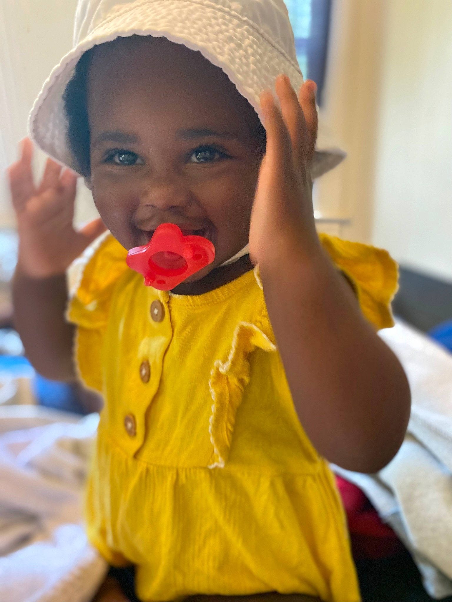 Emani joined the competition — help win amazing prizes! baby, baby_toddler_clothing, cap, cheek, child, event, face, fashion_accessory, finger, fun, happy, headgear, lip, mouth, nose, person, play, sitting, skin, smile