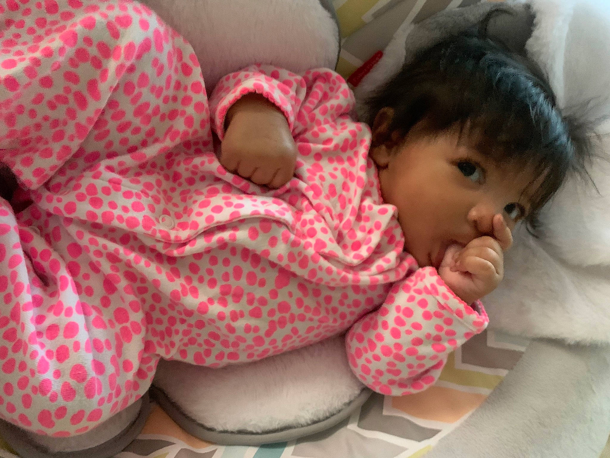 Armani is registered to the contest to win money with this photo: baby, baby_products, baby_sleeping, baby_toddler_clothing, bedding, bedtime, carmine, cheek, child, comfort, headgear, linens, lip, mouth, nose, pattern, person, pink, stuffed_toy, textile
