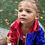 blue, casual, child, colorful, concrete, curious, expression, face_paint, fashion, gold, grass, jacket, outdoor, person, portrait, red, sitting, tattoo, young, young_child
