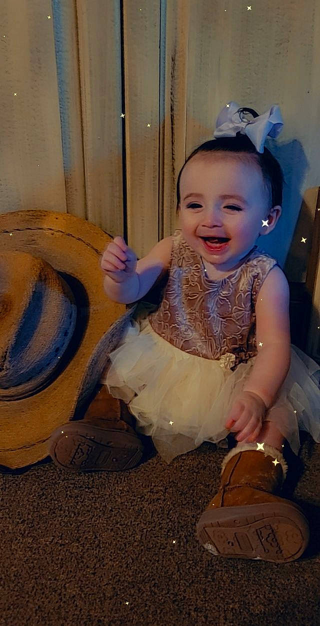 Ava is registered to the contest to win money with this photo: automotive_tire, baby, baby_toddler_clothing, child, costume, dress, event, fashion_accessory, flash_photography, flooring, fun, happy, hat, headband, headpiece, person, purple, sitting, smile, toddler