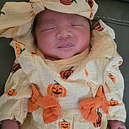 Jayda joined the competition — help win amazing prizes! newborn, baby, sleeping, infant, pumpkin, headwrap, clothing, orange, cute, hands, face, closed_eyes, cozy, fabric, pattern, portrait, resting, child, cute_outfit, soft