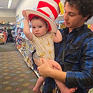 Raiden joined the competition — help win amazing prizes! baby, bookshelf, bookstore, carpet, casual_wear, child, clothing, curious, giraffe_print, hat, holding, indoor, keys, kids_fiction, man, person, serious, shopping, striped_hat, young_adult