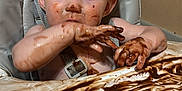 Raiden joined the competition — help win amazing prizes! toddler, child, high_chair, chocolate, messy, face, hands, food, smudged, curious, indoor, baby, expression, seat, tray, skin, hair, candid, feeding, cute