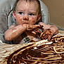 toddler, child, high_chair, chocolate, messy, face, hands, food, smudged, curious, indoor, baby, expression, seat, tray, skin, hair, candid, feeding, cute