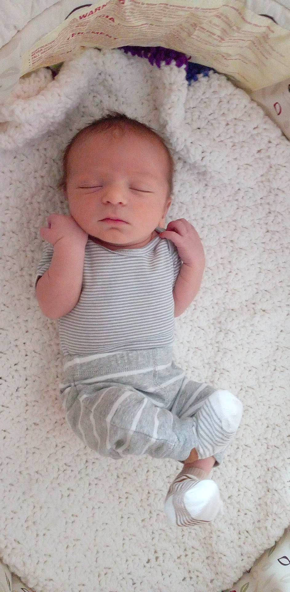 Kaydah Wayne Baker-anthony is registered to the contest to win money with this photo: arm, baby, baby_toddler_clothing, cheek, comfort, eye, face, finger, fun, hand, happy, head, iris, linens, lip, nose, pattern, person, skin, sleeve