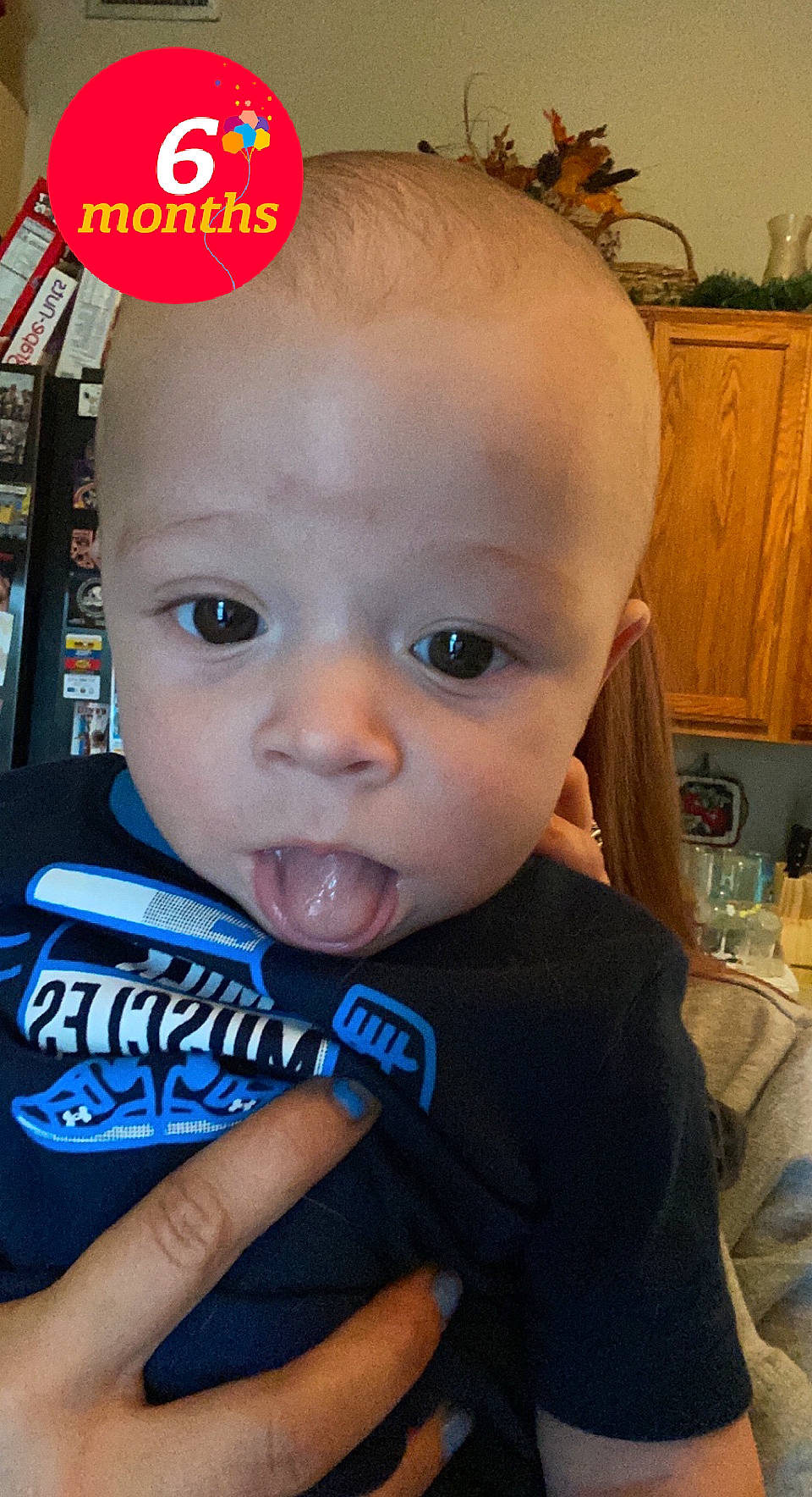 Rhyker is registered to the contest to win money with this photo: baby, baby_toddler_clothing, cabinetry, cheek, chin, ear, eyebrow, eyelash, facial_expression, forehead, fun, happy, houseplant, iris, lip, mouth, nose, person, plant, skin