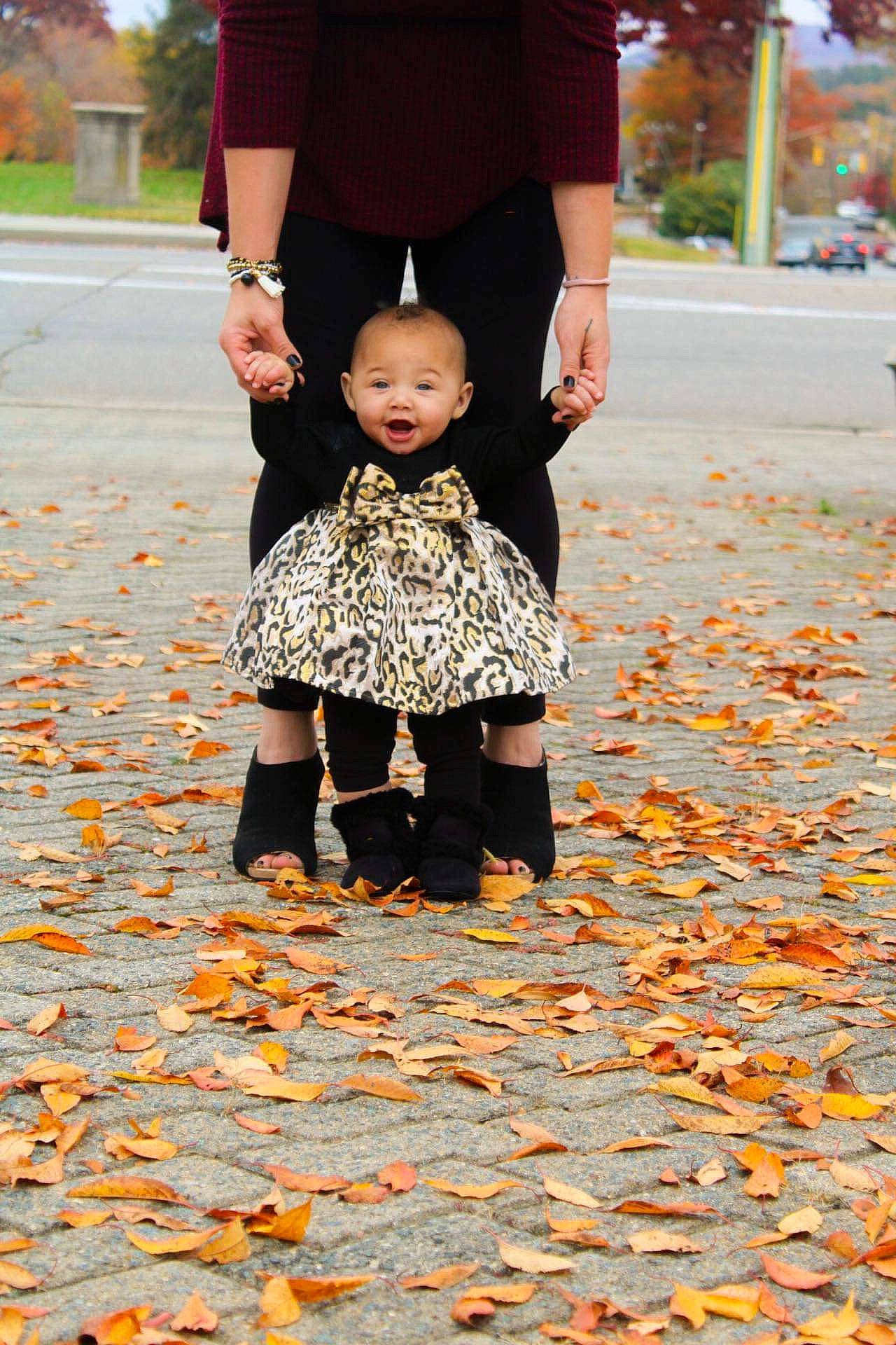 Georgia is registered to the contest to win money with this photo: baby, beauty, dress, flooring, gesture, grass, hand, happy, leg, leisure, orange, people, people_in_nature, person, photograph, plant, sleeve, tints_and_shades, toddler, tree
