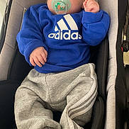 Thybault participe au concours pour gagner de l'argent avec cette photo : baby, infant, sleeping, pacifier, adidas, blue_sweater, grey_pants, car_seat, cozy, child, clothing, indoor, portrait, cute, resting, young_child, socks, comfortable, casual, newborn