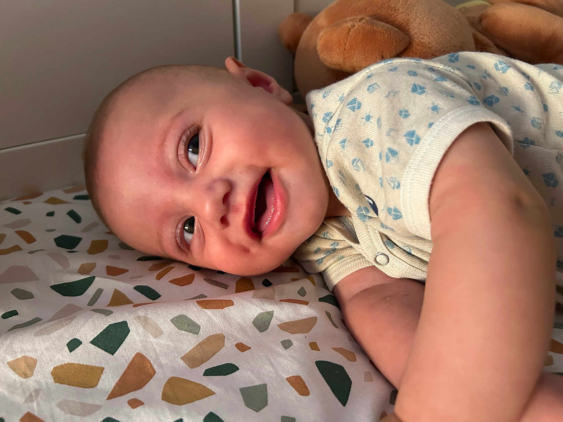 Liham participe au concours pour gagner de l'argent avec cette photo : baby, infant, smiling, face, onesie, bedspread, patterned, plush_toy, teddy_bear, lying_down, happy, child, cute, skin, head, arm, indoors, closeup, portrait, young